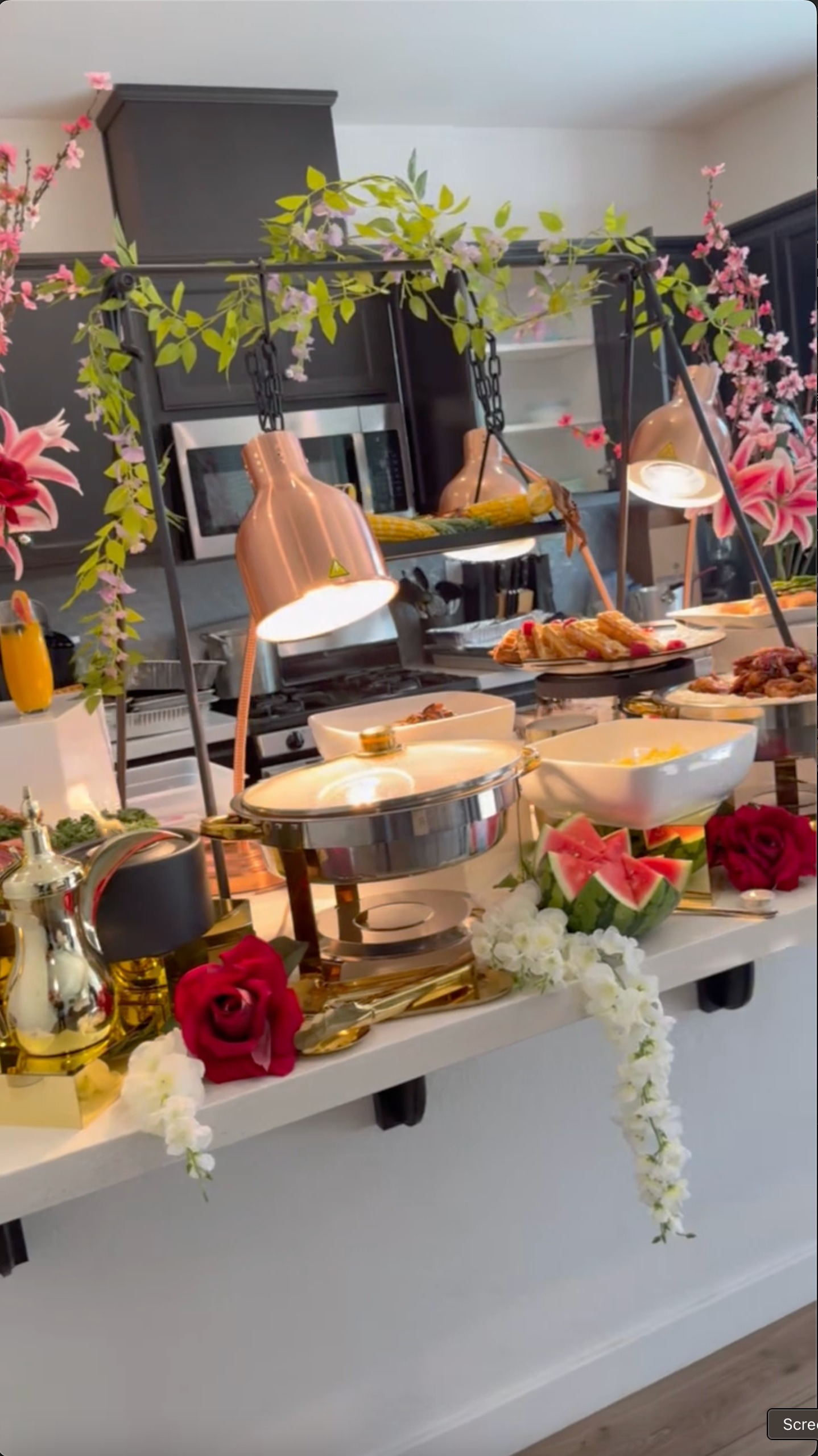 Family gathering birthday brunch with vibrant buffet, champagne, and flowers by Chef G